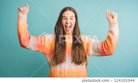Excited woman celebrating success with joyful expression Excited woman celebrating success with joyful expression 124101044