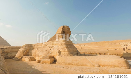 Great sphinx of giza watching over the pyramids on sunny day 124101061