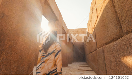 Tourist walking through ancient egyptian temple at sunrise 124101062