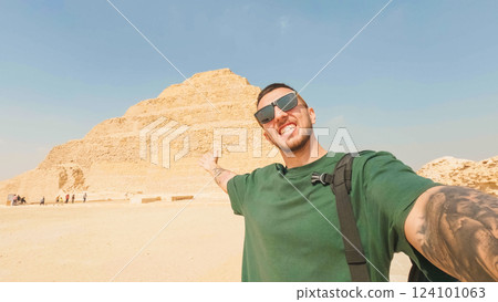 Tourist showing the step pyramid of djoser in saqqara, egypt Tourist showing the step pyramid of djoser in saqqara, egypt 124101063