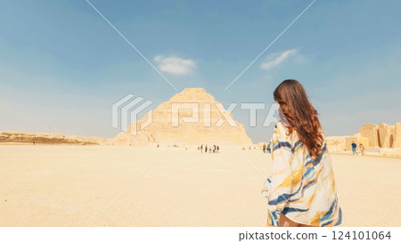Tourist walking towards the step pyramid of djoser in saqqara, egypt 124101064