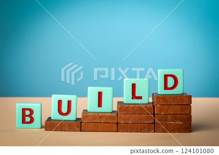 Build Concept. Alphabet blocks on wooden blocks. Light background Build Concept. Alphabet blocks on wooden blocks. Light background 124101080