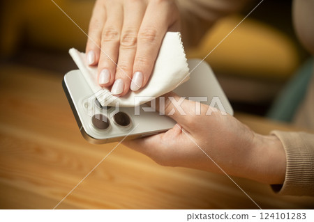 Wiping smartphone camera lenses for clearer pictures and enhanced performance at home 124101283