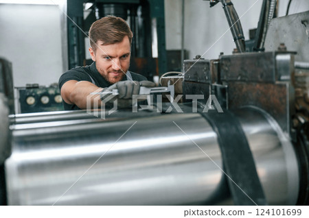 Using measure tool. Man in uniform is in workstation developing details of agriculture technique 124101699
