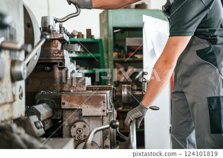 Close up view. Man in uniform is in workstation developing details of agriculture technique 124101819