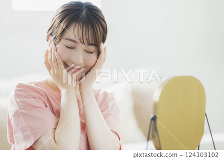 Women in pajamas doing skin care 124103102
