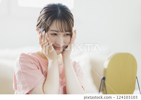 Women in pajamas doing skin care 124103103