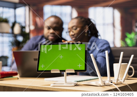 African American couple browse troubleshooting online guide next to chroma key, working together to debug router issues and restore their home network. Freelancers struggle to solve tasks. African American couple browse troubleshooting online guide next to chroma key, working together to debug router issues and restore their home network. Freelancers struggle to solve tasks. 124103405
