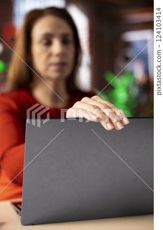 Freelancer at her home office focused on online research and surfing the internet, utilizing a laptop for telework and staying connected in a digital world. Browsing the social media. Freelancer at her home office focused on online research and surfing the internet, utilizing a laptop for telework and staying connected in a digital world. Browsing the social media. 124103414