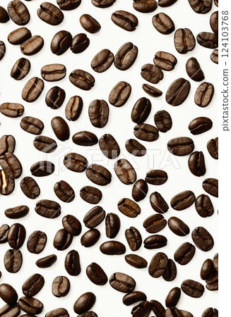 Amid a pristine white backdrop, a scattering of roasted coffee beans reveals their intricate shapes and shades, inviting coffee lovers to explore their rich aromas and flavors Generative AI 124103768