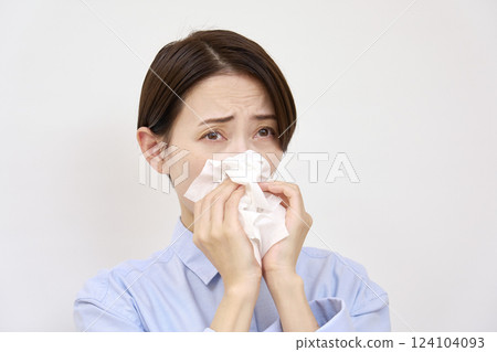 Woman blowing her nose on white background Woman blowing her nose on white background 124104093