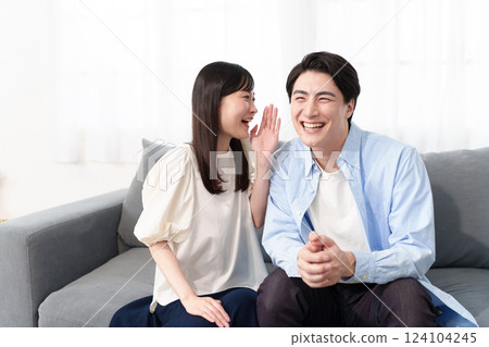 A couple talking secretly A couple talking secretly 124104245