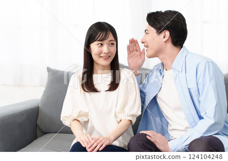 A couple talking secretly A couple talking secretly 124104248