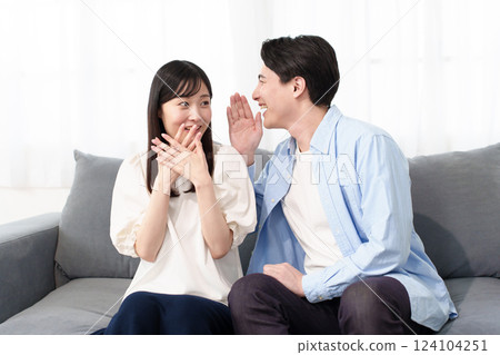 A couple talking secretly A couple talking secretly 124104251