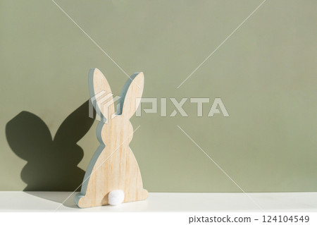 Minimalistic creative Easter concept. Two Easter bunnies under symbolic roof on green background. Celebration Easter holiday at home with family. Poster or greeting card Minimalistic creative Easter concept. Two Easter bunnies under symbolic roof on green background. Celebration Easter holiday at home with family. Poster or greeting card 124104549