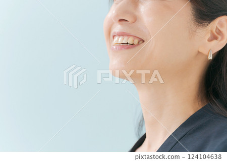 The mouth of a middle-aged woman smiling happily 124104638