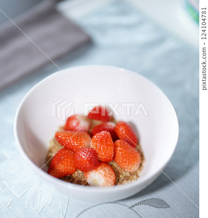 Strawberry with cereal in white bowl. 124104781