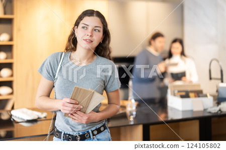 European woman holding wood samples for decoration European woman holding wood samples for decoration 124105802