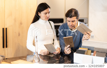 Married couple choosing samples for kitchen decoration 124105807