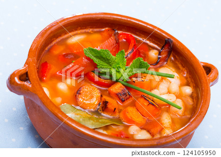 Bean's soup cooked with bean, carrots and pepper, served in bowl 124105950
