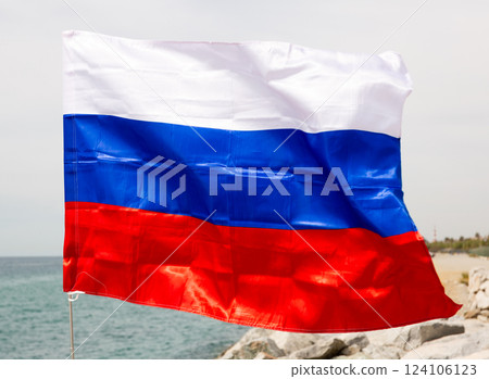 Big flag of Russia flutters against sea Big flag of Russia flutters against sea 124106123
