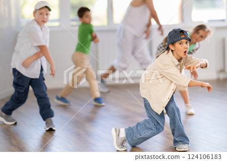 Young boys and girls performing hip hop at group dance class in choreographic studio 124106183