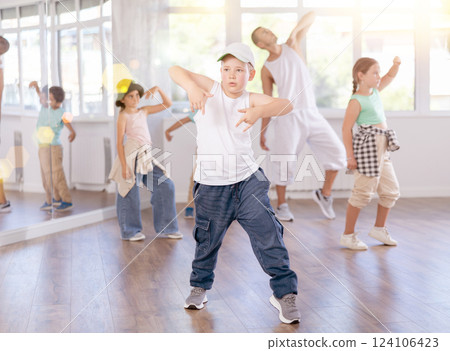 Preteen boy honing hip hop dance moves in choreographic studio Preteen boy honing hip hop dance moves in choreographic studio 124106423