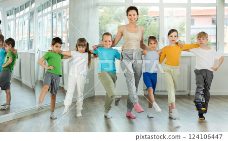 Preteen children and doing cancan dance together with female trainer 124106447