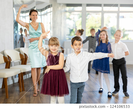 Children dance in pairs at festive matinee Children dance in pairs at festive matinee 124106533