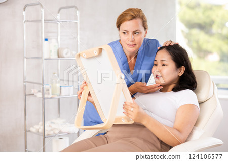 Middle-aged woman consulting with mirror 124106577