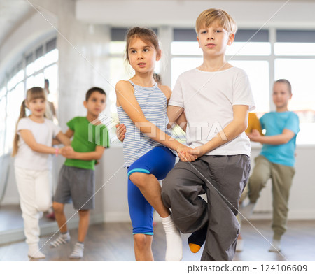 Positive juvenile boy and girl engaged in Rock 'n' Roll dance during dancing classes 124106609