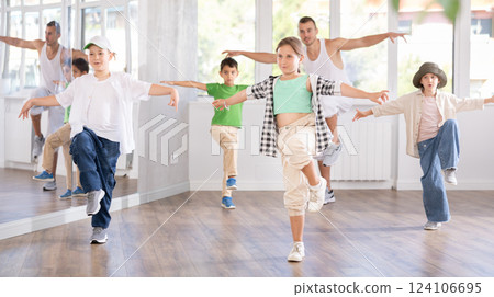 Tween girl dancer rehearsing krump dance at group workout Tween girl dancer rehearsing krump dance at group workout 124106695