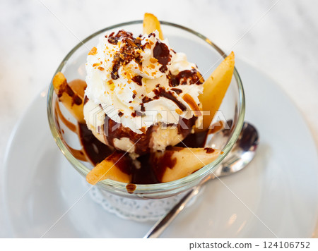 Dessert Poires belle Helene of pear with ice cream and chocolate sauce Dessert Poires belle Helene of pear with ice cream and chocolate sauce 124106752