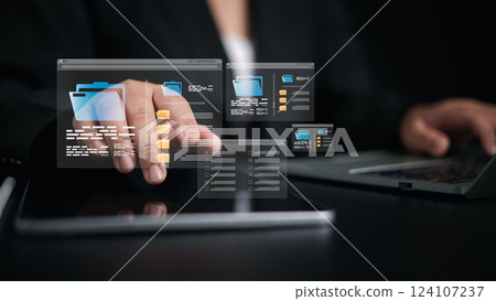 Document Management System (DMS) being setup by IT consultant working on laptop computer in office, Businesswoman using computer to document management, Workflow sharing, Backup online document files Document Management System (DMS) being setup by IT consultant working on laptop computer in office, Businesswoman using computer to document management, Workflow sharing, Backup online document files 124107237
