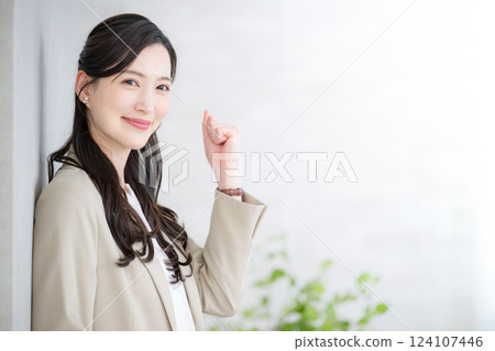A beautiful woman in a suit with a laptop computer looks at the camera and gives a fist pump. For job changes, recruitment, human resources, consulting A beautiful woman in a suit with a laptop computer looks at the camera and gives a fist pump. For job changes, recruitment, human resources, consulting 124107446