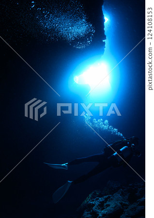 Diver looking up at the light from underwater, Miyakojima, Cross Hole 124108153