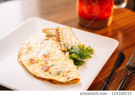 Omelette for breakfast with champignons and sauce 124108515