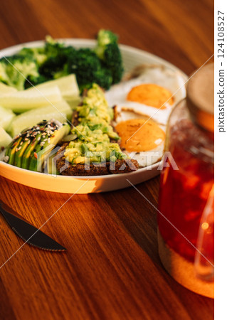 Healthy breakfast egg avocado greens and salad and raspberry tea Healthy breakfast egg avocado greens and salad and raspberry tea 124108527