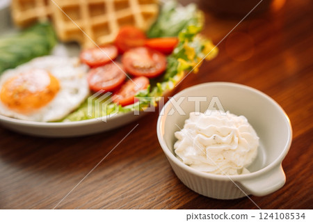 Egg with waffles and raspberry tea for breakfast Egg with waffles and raspberry tea for breakfast 124108534