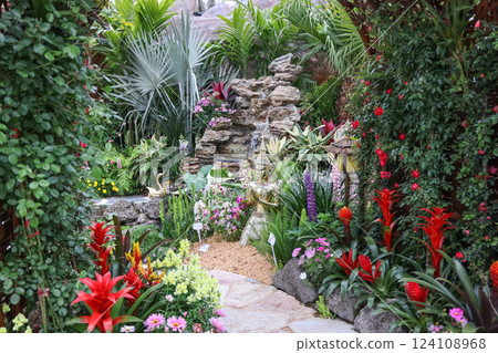 Lush Garden Pathway Surrounded by Vibrant Flowers 124108968