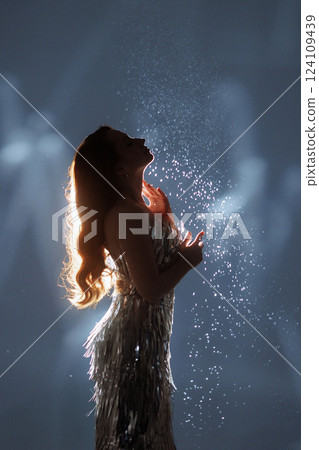Glamorous Woman in Sparkling Light and Falling Glitter Glamorous Woman in Sparkling Light and Falling Glitter 124109439
