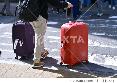 Tokyo cityscape in Japan XEC stocks... Inbound tourism continues... Tourists with suitcases near Azumabashi intersection... Sensoji Temple is in the far right 124110783