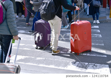 Tokyo cityscape in Japan XEC stocks... Inbound tourism continues... Tourists with suitcases near Azumabashi intersection... Sensoji Temple is in the far right 124110784