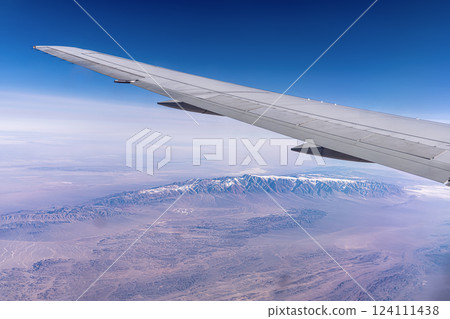 The Kunlun Mountain Range in the Tibetan Plateau in China. View from a high altitude from under the wing of an airplane from the window 124111438