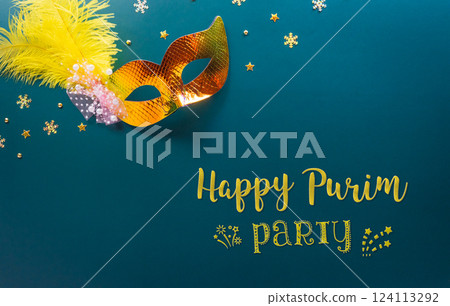 Happy Purim carnival decoration concept made from golden mask star and glitter on dark background. (Happy Purim in Hebrew, jewish holiday celebrate) 124113292