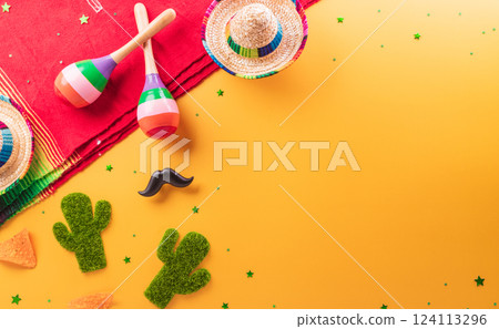 Cinco de Mayo holiday background made from maracas, cactus and hat on yellow background. Cinco de Mayo holiday background made from maracas, cactus and hat on yellow background. 124113296