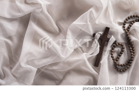 Good Friday and Holy week concept - A religious cross on white fabric background. Good Friday and Holy week concept - A religious cross on white fabric background. 124113300