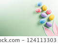 Easter party concept. Top view of easter bunny ears and colorful eggs on pastel background with copyspace for the text. 124113303