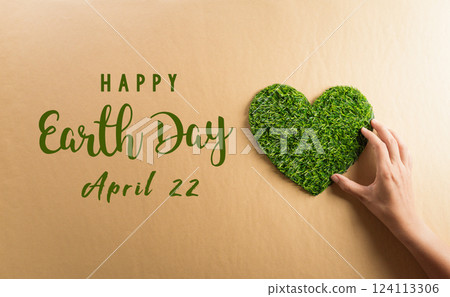 Hands holding green heart on brown background. World environment day, earth day and save earth concept. 124113306