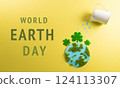World environment day, earth day, save earth and eco concept. Concept of watering handmade globe from grass and paper on yellow background. 124113307